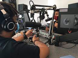 Student at on air mic at the radio station